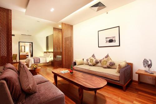 a living room with a couch and a table at Truntum Kuta Bali in Kuta
