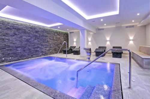 a hot tub in a room with a brick wall at Grupotel Ibiza Beach Resort - Adults Only in Portinatx