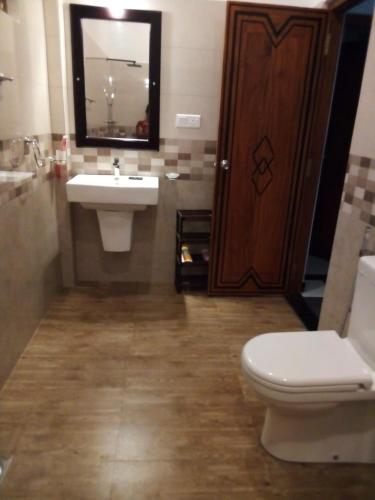 a bathroom with a sink and a toilet and a mirror at Charly Villa in Haburugala