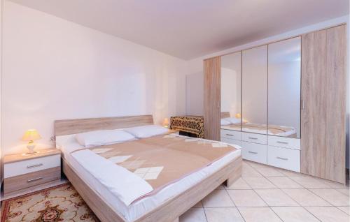 a bedroom with a large bed and a mirror at 1 Bedroom Gorgeous Apartment In Selce in Selce
