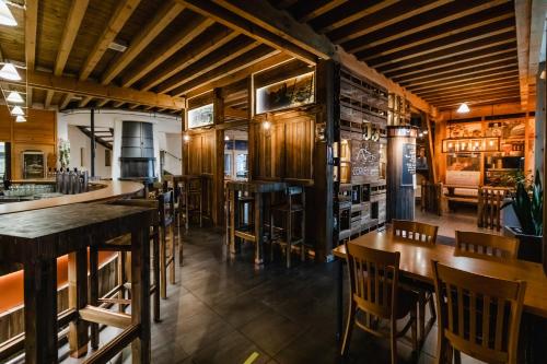 a restaurant with wooden floors and tables and chairs at Hotel Cornelyshaff in Heinerscheid
