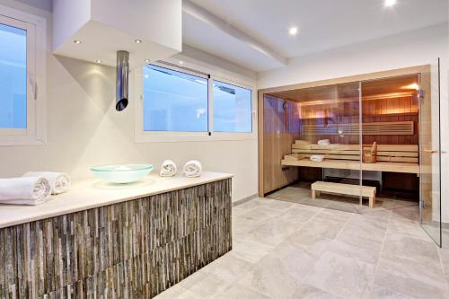 
a bathroom with a tub, sink, and toilet at Grupotel Ibiza Beach Resort - Adults Only in Portinatx

