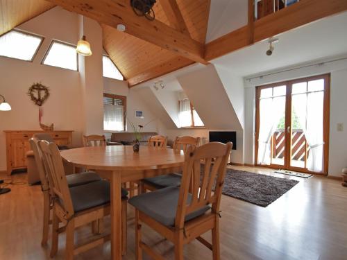 a dining room with a wooden table and chairs at Countryside apartment with garden in Schallstadt