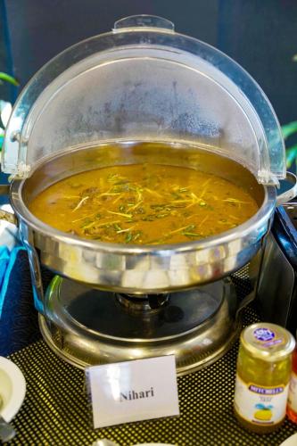 a pot of soup sitting on top of a table at Trivelles Executive Suites Islamabad in Islamabad
