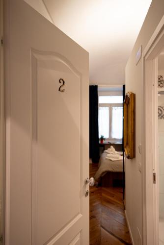 a door with a question mark on it leading to a bedroom at LE MADAMINE ROOMS in Turin