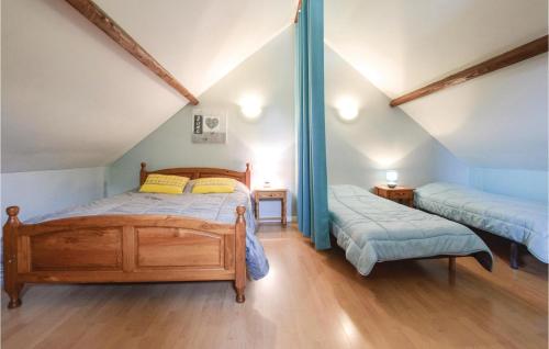 a bedroom with two beds in a attic at Nice Home In La Cambe With Kitchen in La Cambe