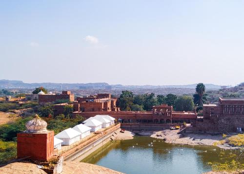 a view of a town with a river and buildings at Bijolai Palace - A Inde Hotel , Jodhpur in Jodhpur