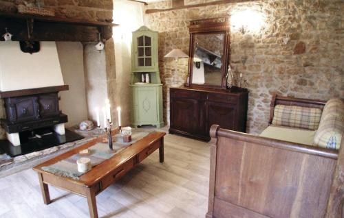 a living room with a couch and a table at Awesome Home In Granges D'ans in Granges-dʼAns