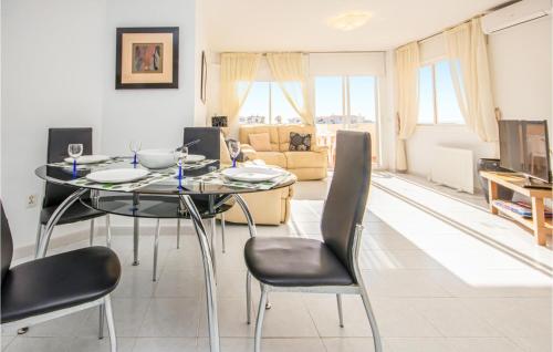 a living room with a dining room table and chairs at Nice Apartment In Rivera Del Sol in La Cala de Mijas