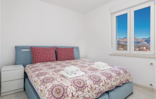 a bedroom with a bed with two towels on it at Nice Apartment In Cavle With 2 Bedrooms And Wifi in Čavle