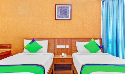 a hotel room with two beds and a picture on the wall at Treebo The Grand Skyla Marathahalli in Bengaluru