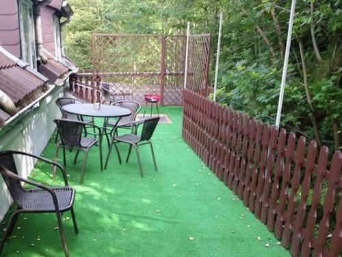 a patio with tables and chairs on the grass at Spacious Haven in Wildemann in Wildemann
