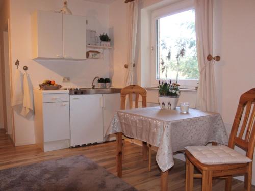 a kitchen with a table and chairs and a sink at Apartment in Kirchdorf with Swimming Pool Garden Terrace in Kirchdorf