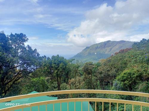 a balcony with a view of a mountain valley at Deshadan Mountain Resort -The highest resort in Munnar in Munnar