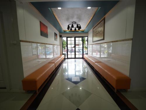 a waiting room with benches in a building at RoomQuest Rojana Industrial Estate area in Ban Nong Phai