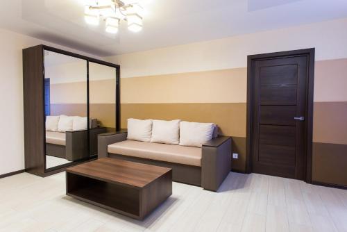 a room with a couch and a table and a mirror at Luxury One bedrooms 23 August in Kharkiv