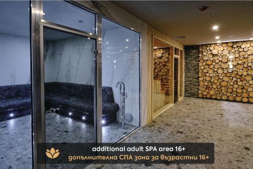 a room with a glass door with a couch in it at SPA Resort St Ivan Rilski - Halfboard & All Inclusive in Bansko