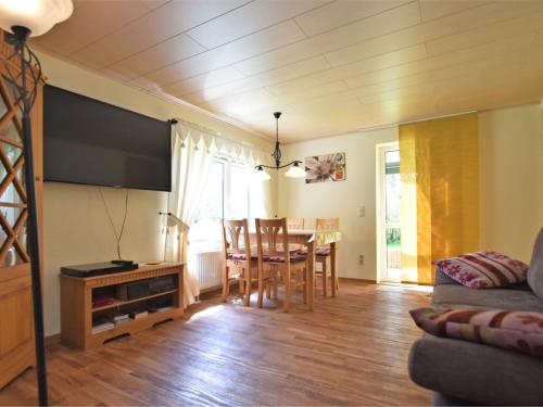 a living room with a table and a dining room at Apartment in Saxony with terrace in Scheibenberg