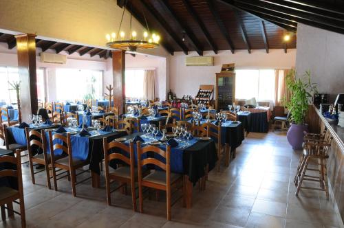 a banquet hall with tables and chairs with blue table settings at Arapey Oasis Termal Hotel in Termas del Arapey
