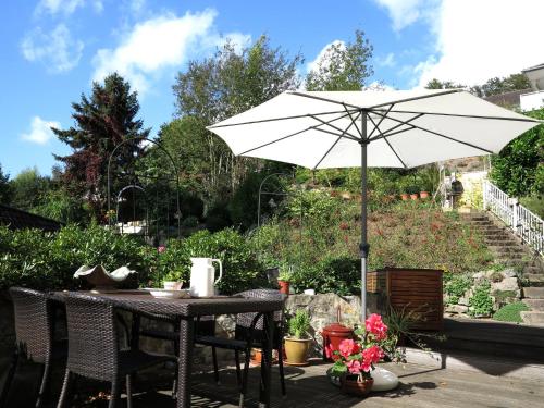 a table with an umbrella on a patio at Villa with a view of the Weserbergland in Bad Pyrmont
