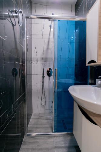 a bathroom with a shower and a sink at La Gioia Apartment in Tirana