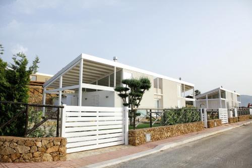 a house with a white fence on the side of a street at Case Vacanza Viola di Mare in Custonaci