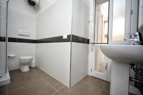a bathroom with a sink and a toilet at Case Vacanza Viola di Mare in Custonaci