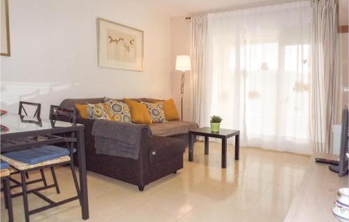 a living room with a couch and a table at Nice Apartment In Denia With Wifi in Denia