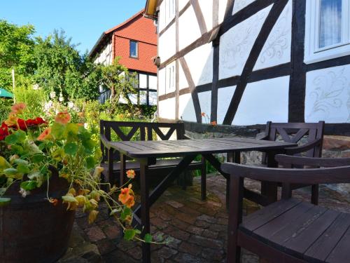 a patio with a table and chairs and a potted plant at Holiday home in Hesse with garden in Willingshausen