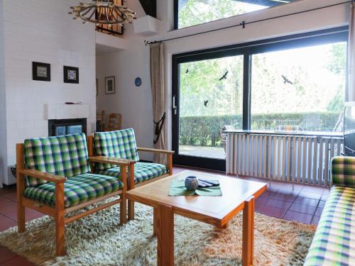 a living room with two chairs and a coffee table at Holiday home in Lissendorfer with terrace in Lissendorf