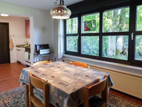 a dining room with a table and some windows at Holiday home in Lissendorfer with terrace in Lissendorf