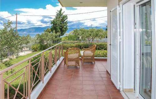 a balcony with two chairs and a view of the ocean at Two-Bedroom Holiday Home In Livanates in Livanátai