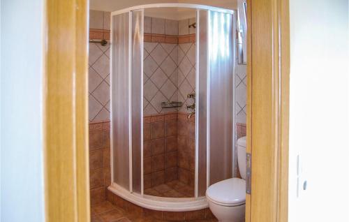 a bathroom with a shower with a toilet in it at Two-Bedroom Holiday Home In Livanates in Livanátai