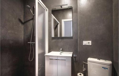 ein Badezimmer mit einem Waschbecken, einem Spiegel und einem WC in der Unterkunft Amazing Apartment In Blanes With Kitchen in Blanes
