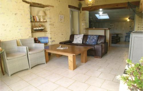 a living room with a couch and a coffee table at Beautiful Home In La Jonchere in La Jonchère