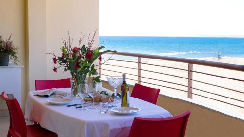 a table with a glass of wine on it at Residence Mediterraneo in Marina di Grosseto