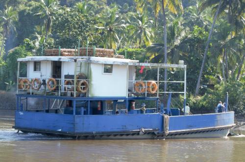 a blue ferry boat on the river at Marias house in Siroda