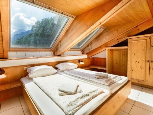 two beds in a room with a window at Cosy apartment in Sch nau am K nigsee with balcony in Schönau am Königssee