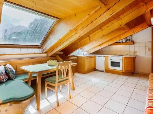 a kitchen with a table and chairs and a window at Cosy apartment in Sch nau am K nigsee with balcony in Schönau am Königssee