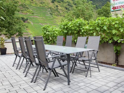 a table and chairs sitting on a patio at Pleasant Apartment in Ernst bei Cochem with Garden in Ernst