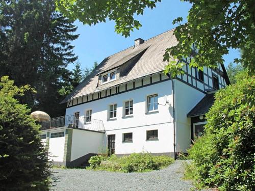 a large white house with a gambrel roof at Idyllic holiday home near the ski area in Winterberg