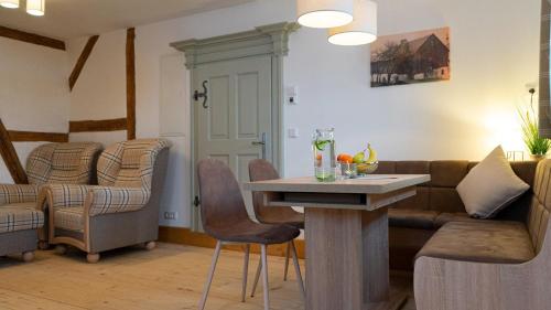 a living room with a couch and a table at Mühlenhof Mähring in Mähring