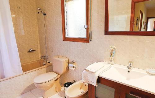 a bathroom with a toilet and a sink and a mirror at Awesome Apartment In Santa Cristina Daro With Kitchen in Santa Cristina d'Aro