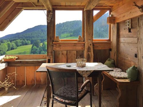 a table and chairs in a room with a window at Holiday home in the Black Forest with sauna in Berneck