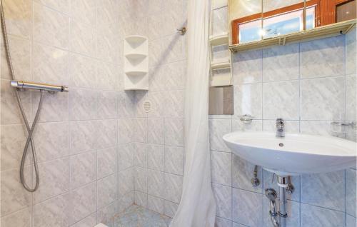 a bathroom with a sink and a shower at Stunning Apartment In Crikvenica With Wifi in Crikvenica