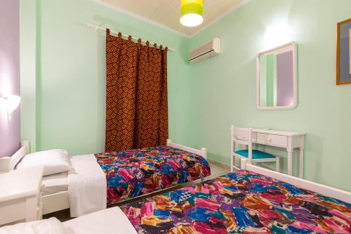 a hospital room with two beds and a mirror at Ni-Mar Studios & Apartments in Lithakia
