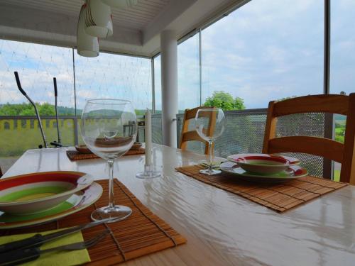 a table with two glasses of wine on top of it at Luxurious Holiday Home in T nnesberg with Garden in Tännesberg