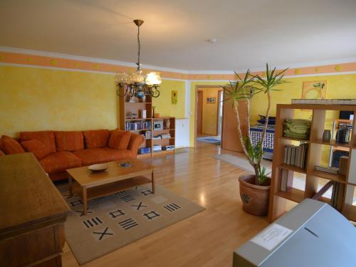 a living room with a couch and a table at Luxurious Holiday Home in T nnesberg with Garden in Tännesberg