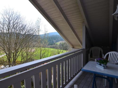 a porch with a table and chairs and a view at Flat with sauna in the Bavarian Forest in Waldkirchen