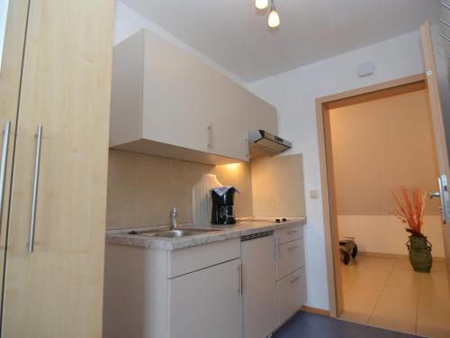 a kitchen with white cabinets and a sink at Wohnung in Rotthalmünster mit Garten in Andriching